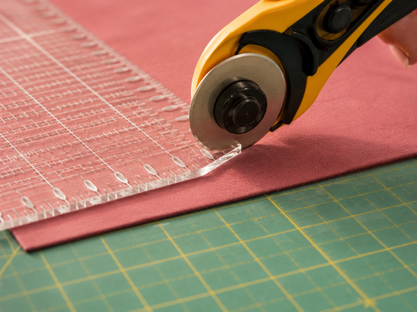 Your cuts are not crooked because of your hands. They are crooked because your ruler has no way to stop the blade from drifting.